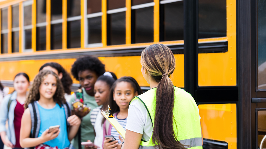 Students boarding a bus as part of early morning field trip charter bus services for schools in New England