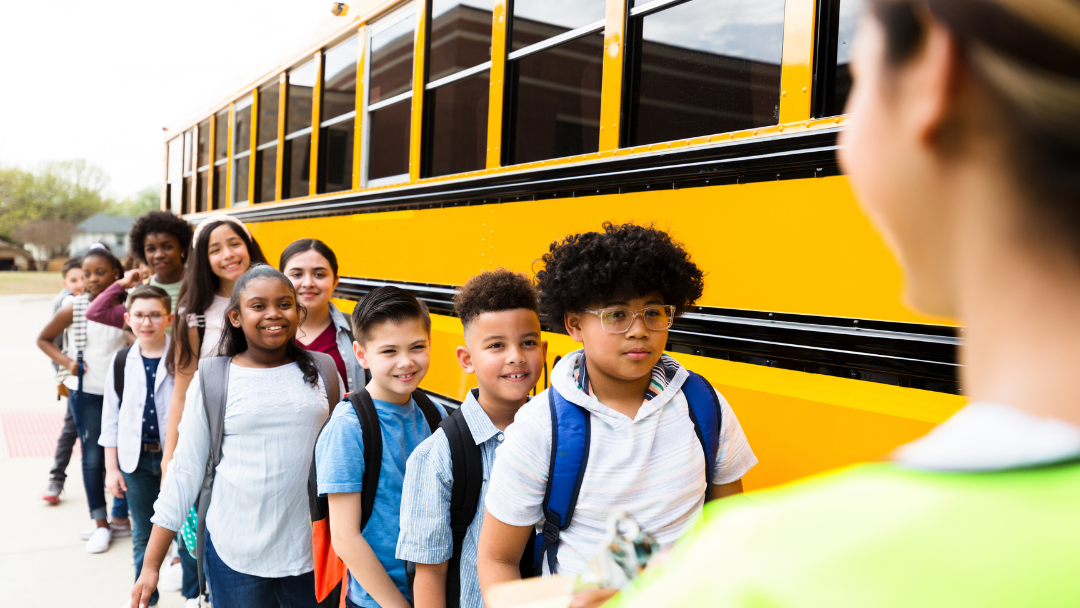 Yellow school bus parked for a Massachusetts field trip with safety equipment visible
